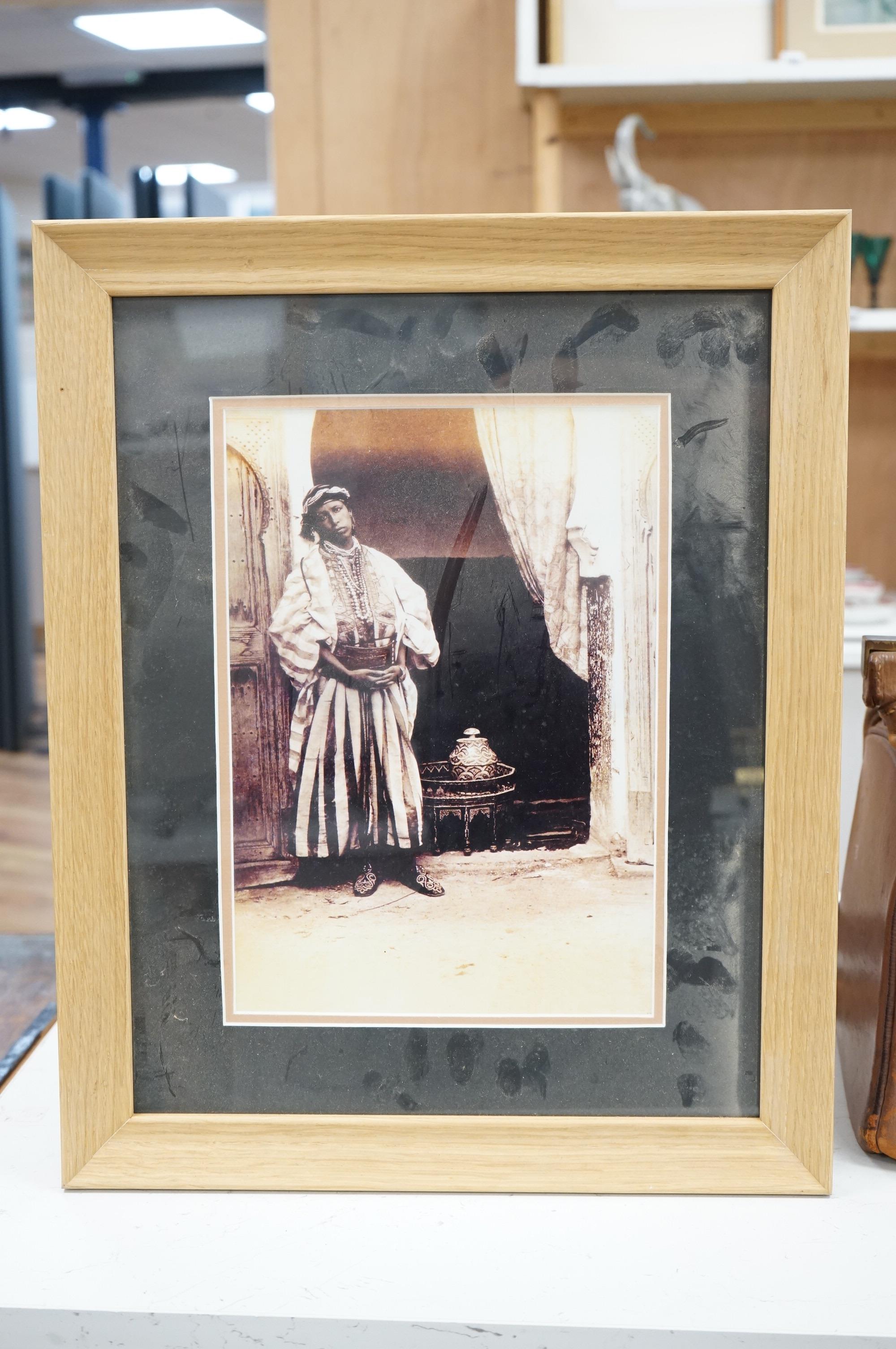 A set of four black and white photographs, Orientalist scenes to include pottery painting and a woman at a loom, 29 x 19cm, together with another